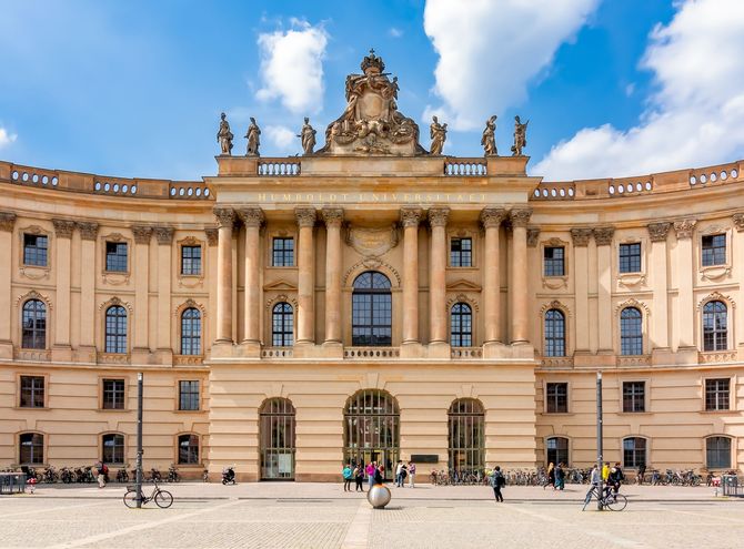A large building with columns and statues on top of it