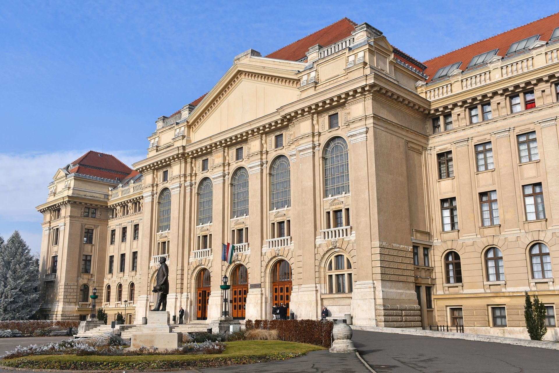 A large building with a statue in front of it