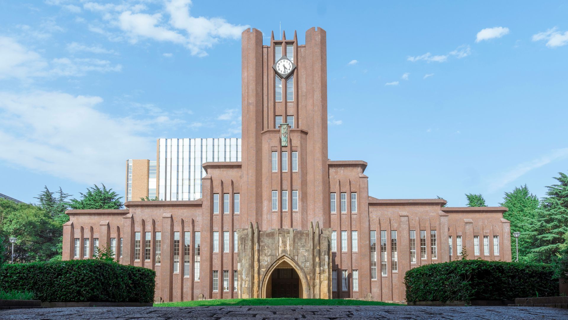 A large brick building with a clock on top of it.