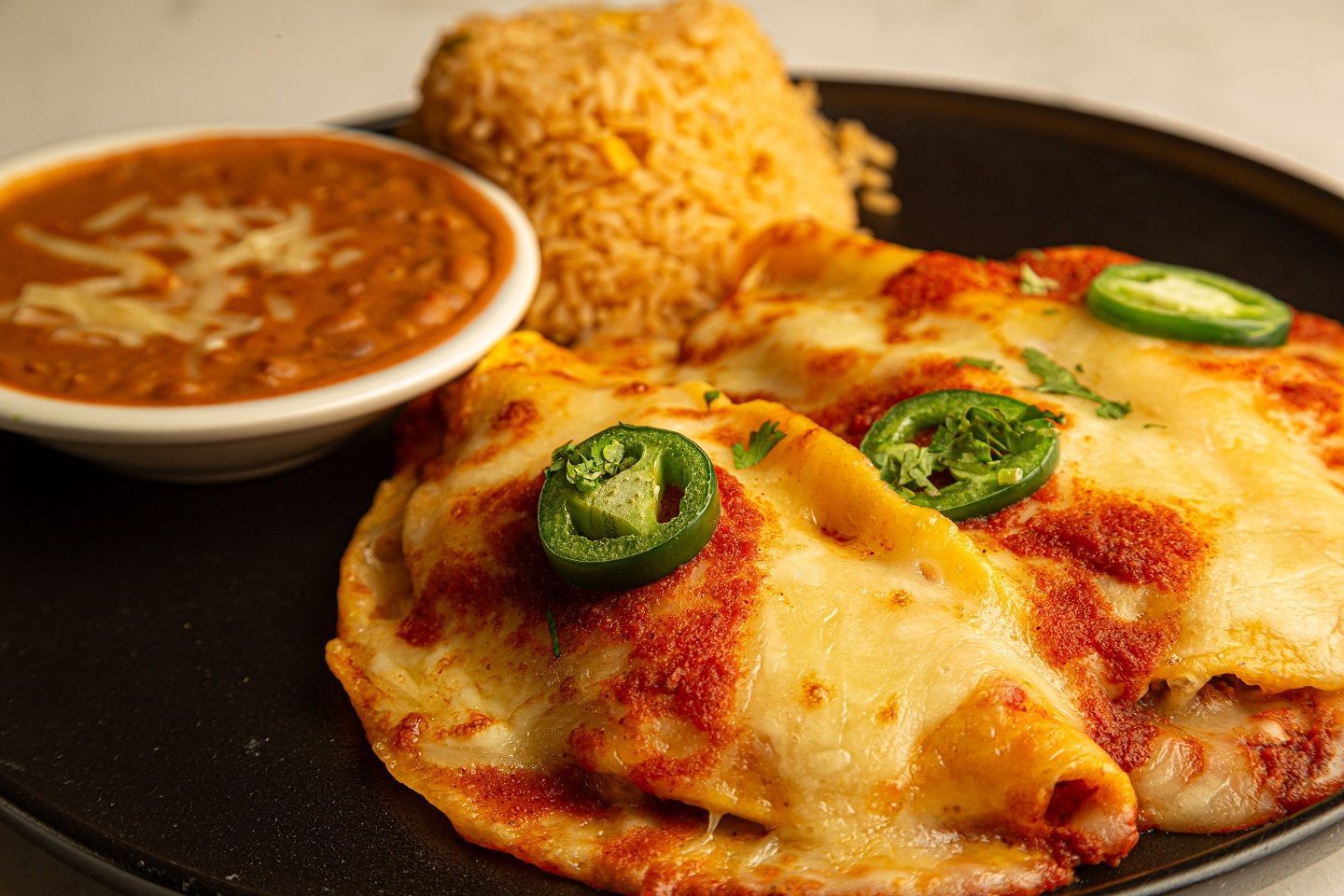 A close up of a plate of food with rice and beans on a table.