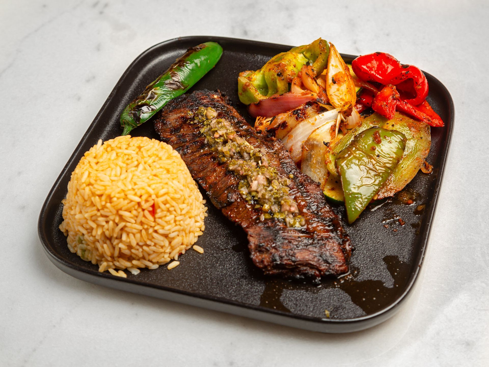 A plate of food with rice and vegetables on a table.