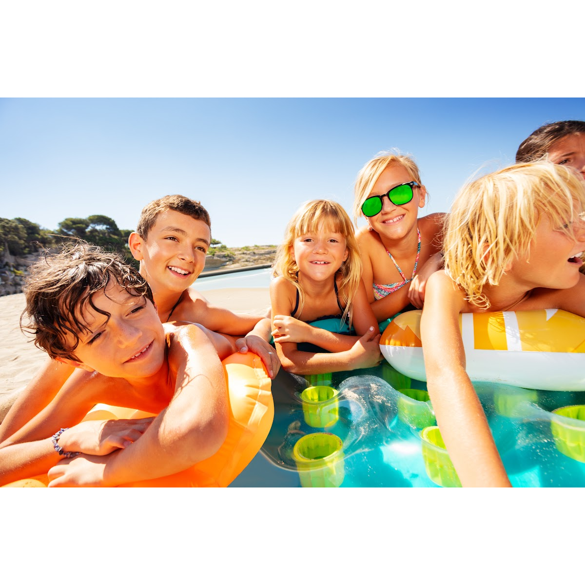 A group of children are playing in a pool.