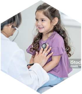 A little girl is being examined by a doctor with a stethoscope