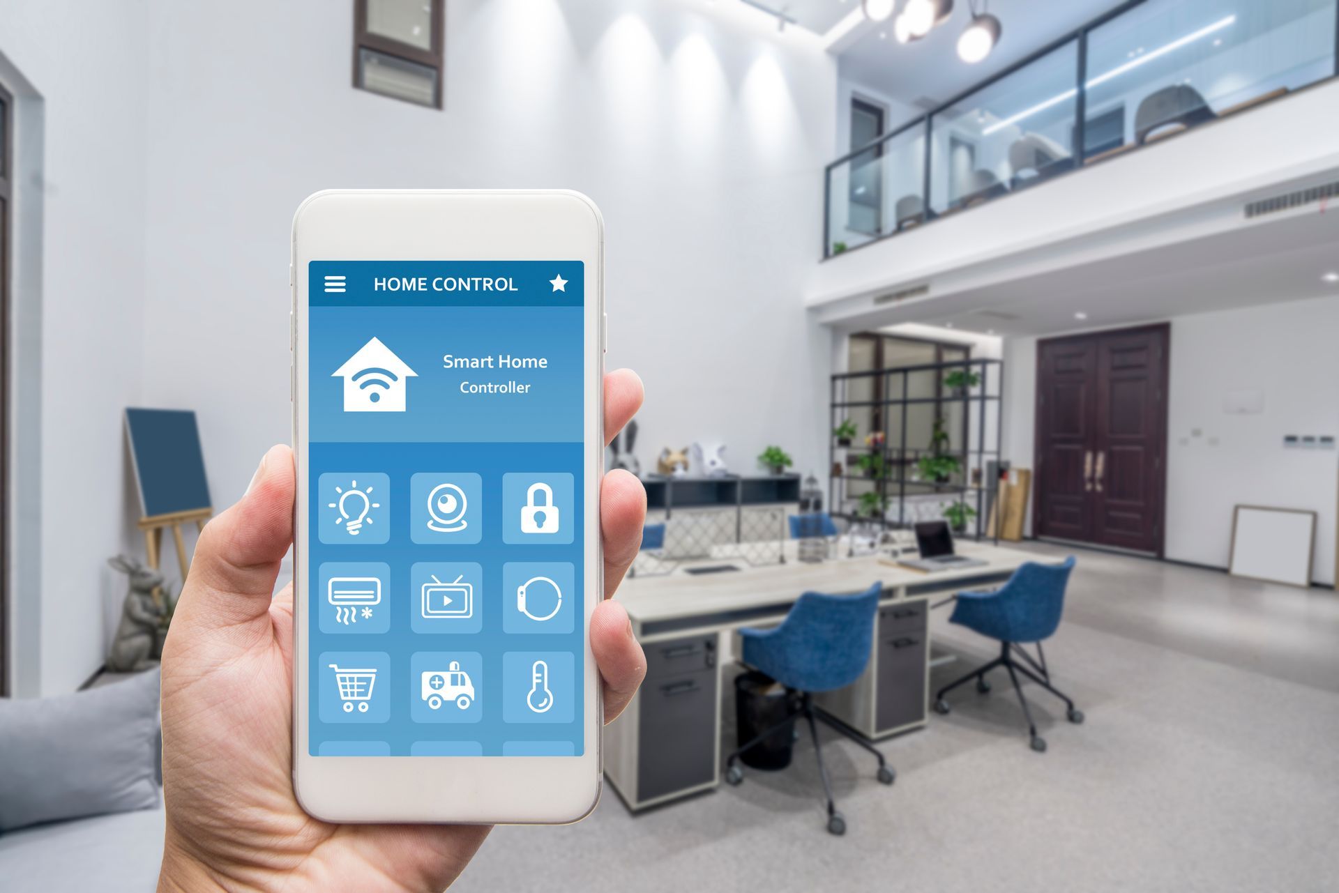 Hand holding smartphone with smart home controls in a bright modern apartment interior