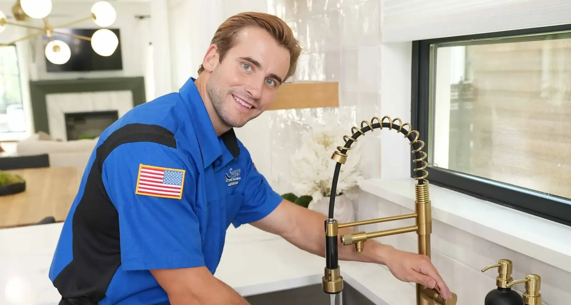 Two men are standing next to each other in front of an air conditioner.