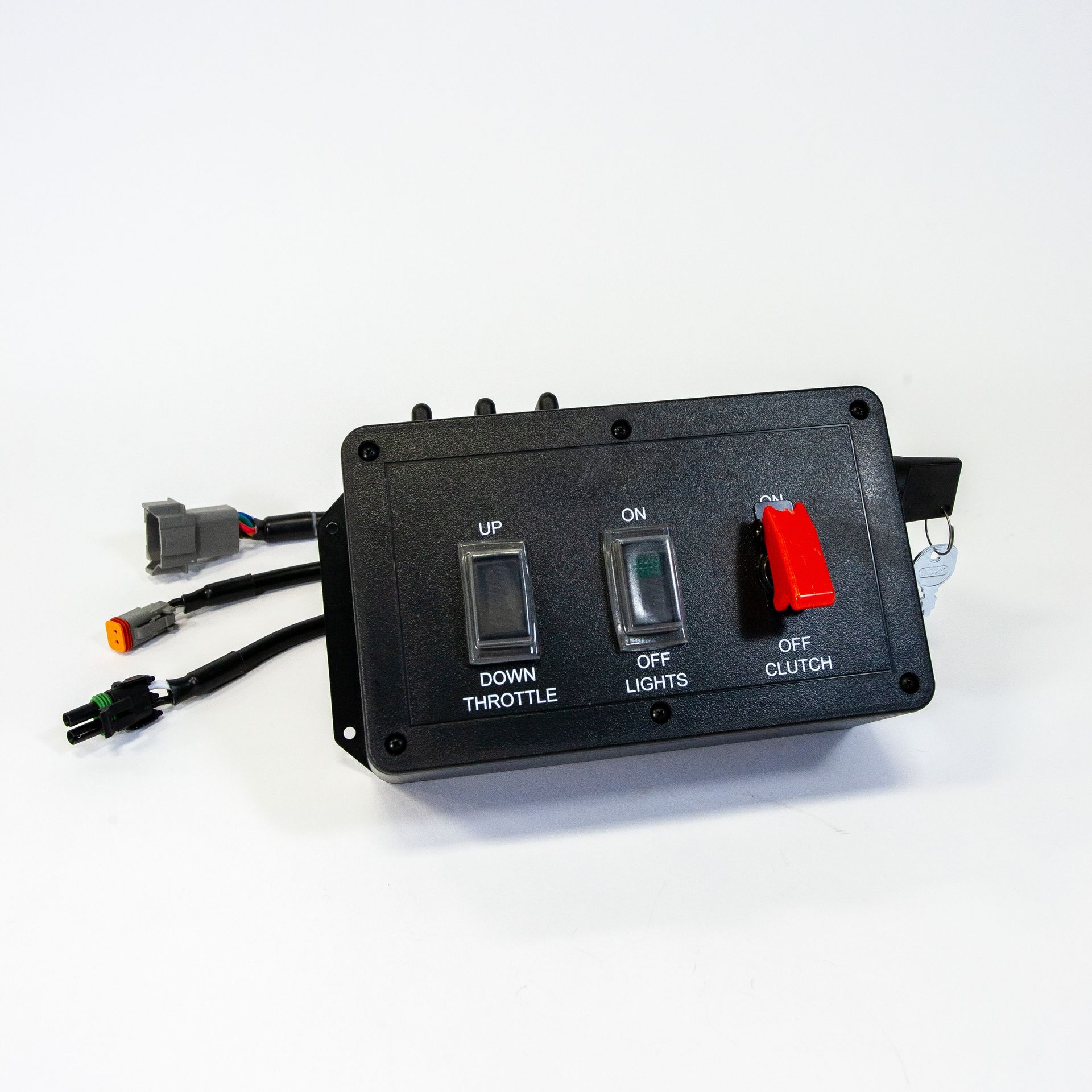 A black box with two switches and a red button on it.