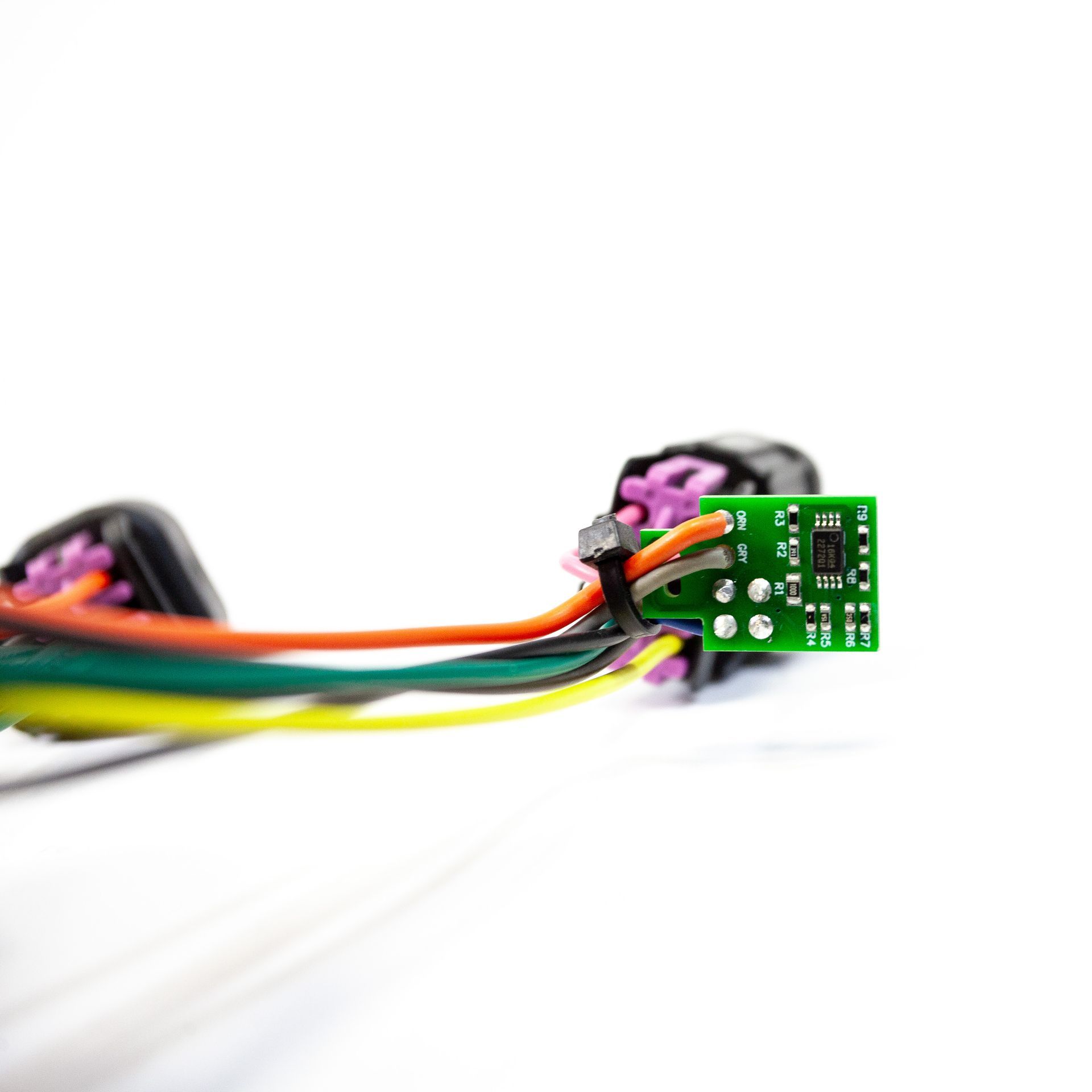 A bunch of wires are connected to a green board