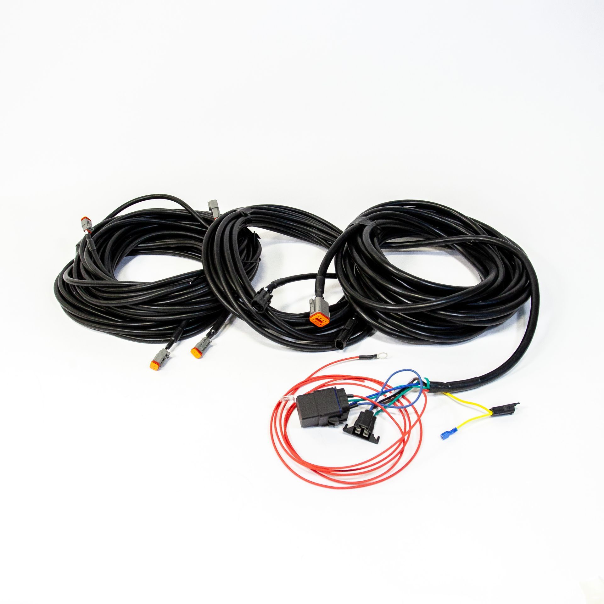 A bunch of wires are hanging on a wooden wall