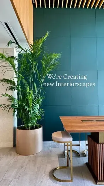 A room with a table and chairs and a sign that says `` we 're creating new interiorscapes ''