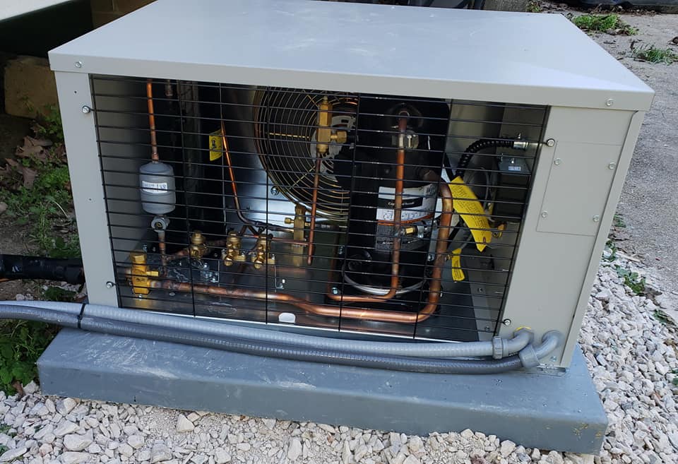 A gray box with copper pipes inside of it