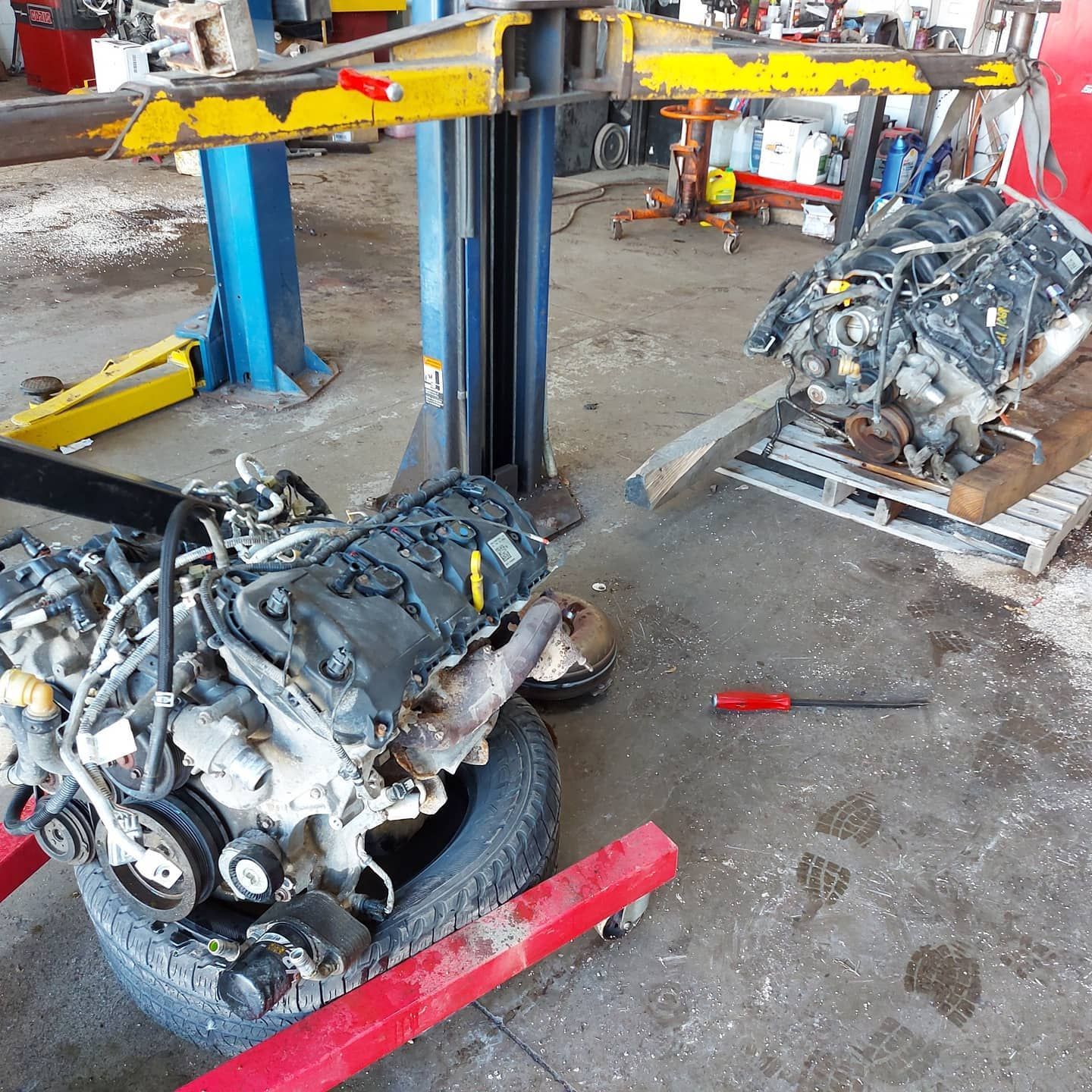 Two engines are being worked on in a garage