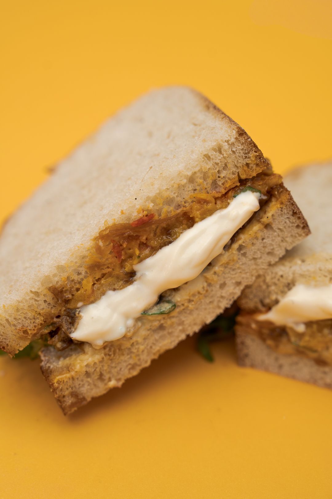 Messalina Sandwich on a mustard yellow background