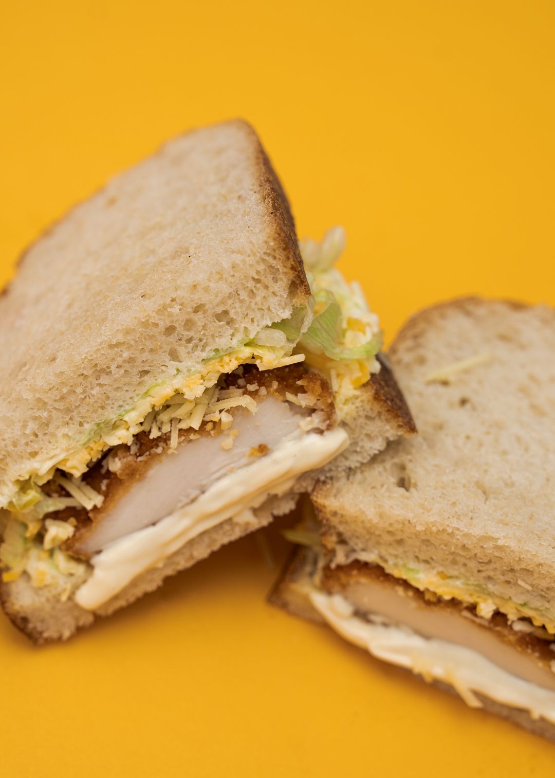 The Schnitty sandwich on a mustard yellow background