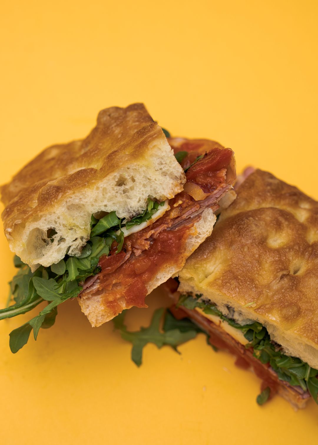 Triple Threat Sandwich on a mustard yellow background