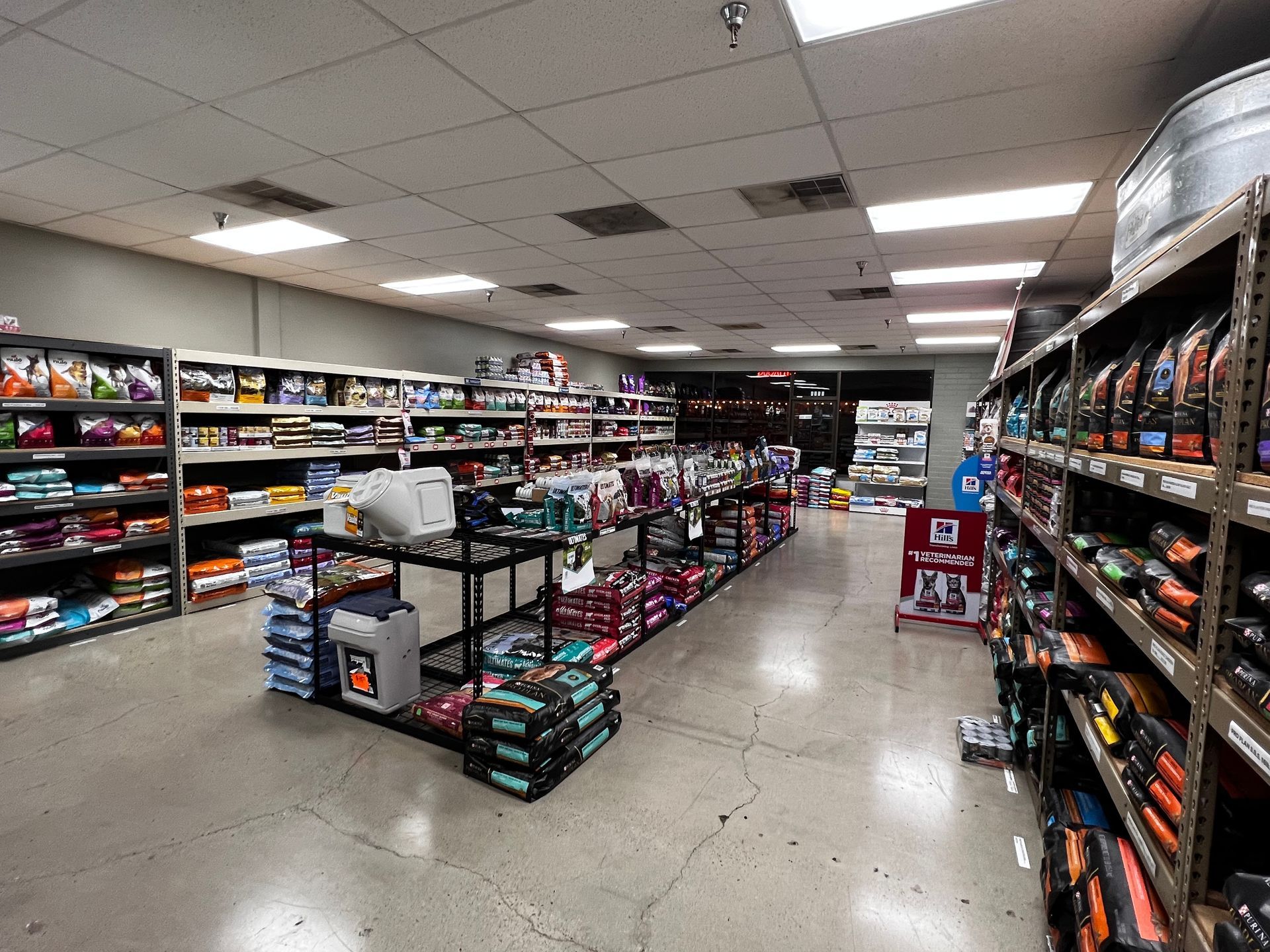 Convenience store aisle with shelves of snacks and drinks under bright fluorescent lights