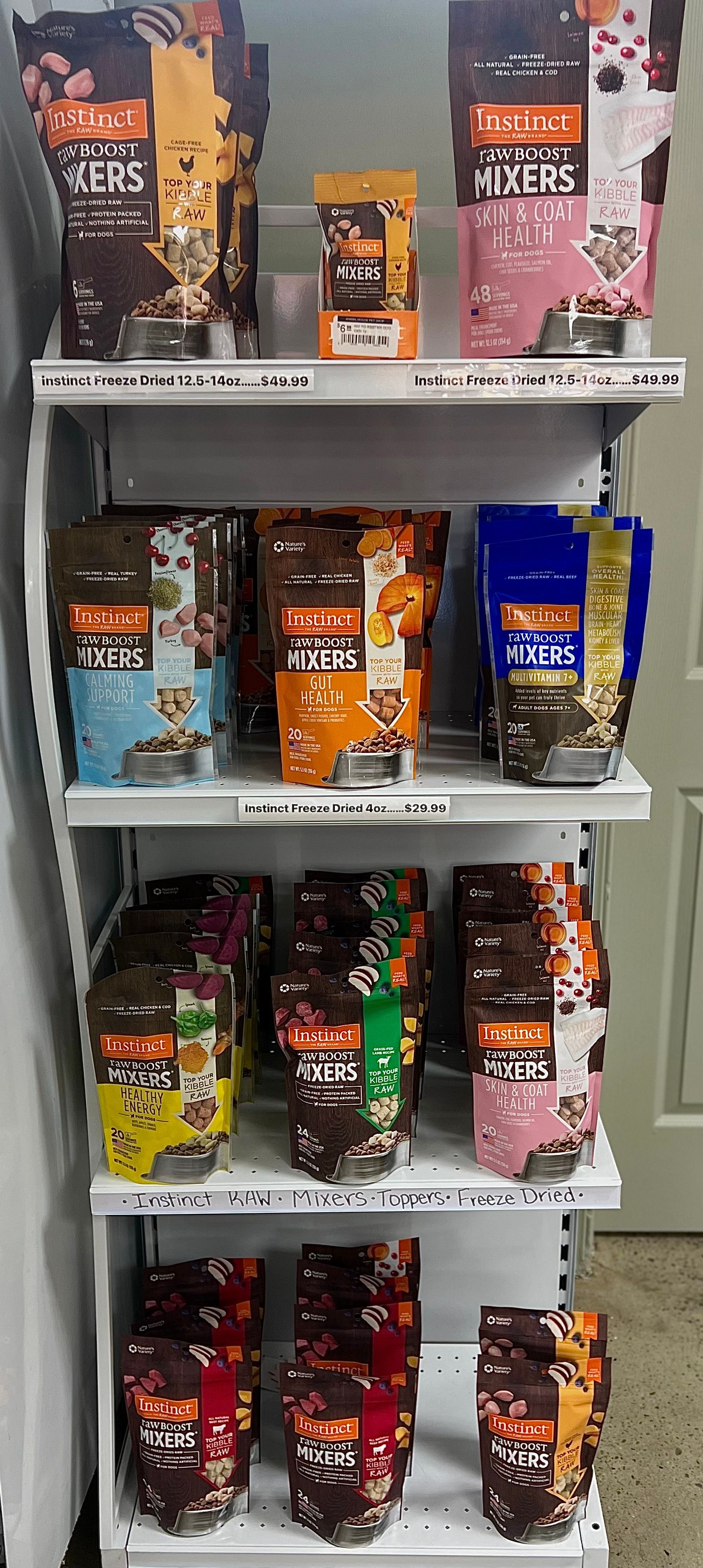 Animal House Pet & Supplies store shelf with assorted colorful packaged snack bags on display