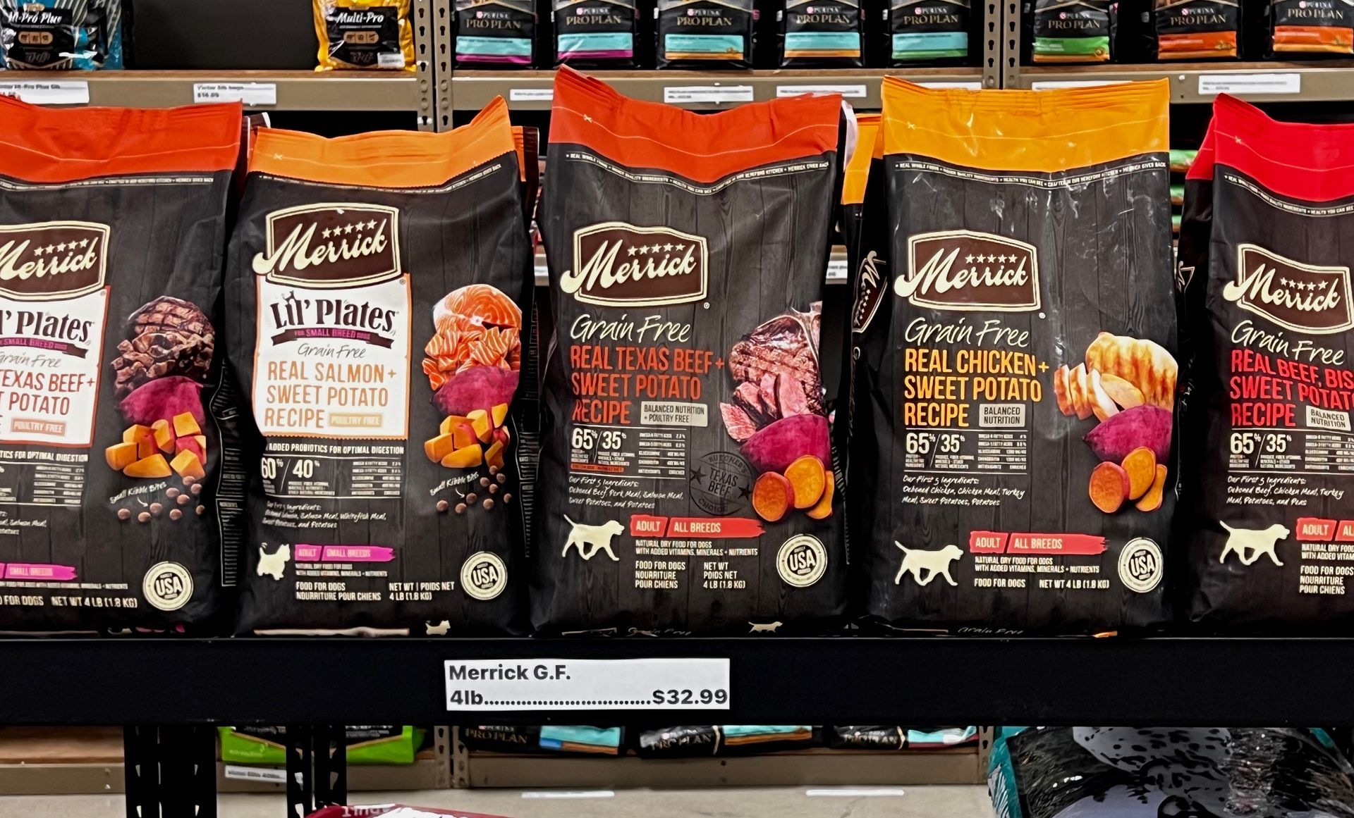 Animal House Pet & Supplies row of cat food bags on a grocery shelf, with black packaging and orange accents.