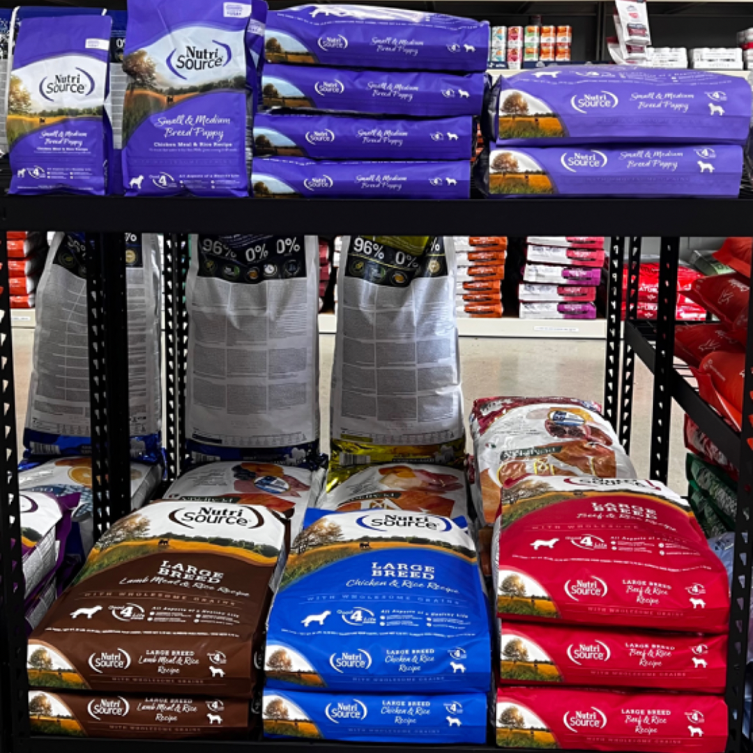 Animal House Pet & Supplies shelves stacked with colorful bags of pet food in a store aisle
