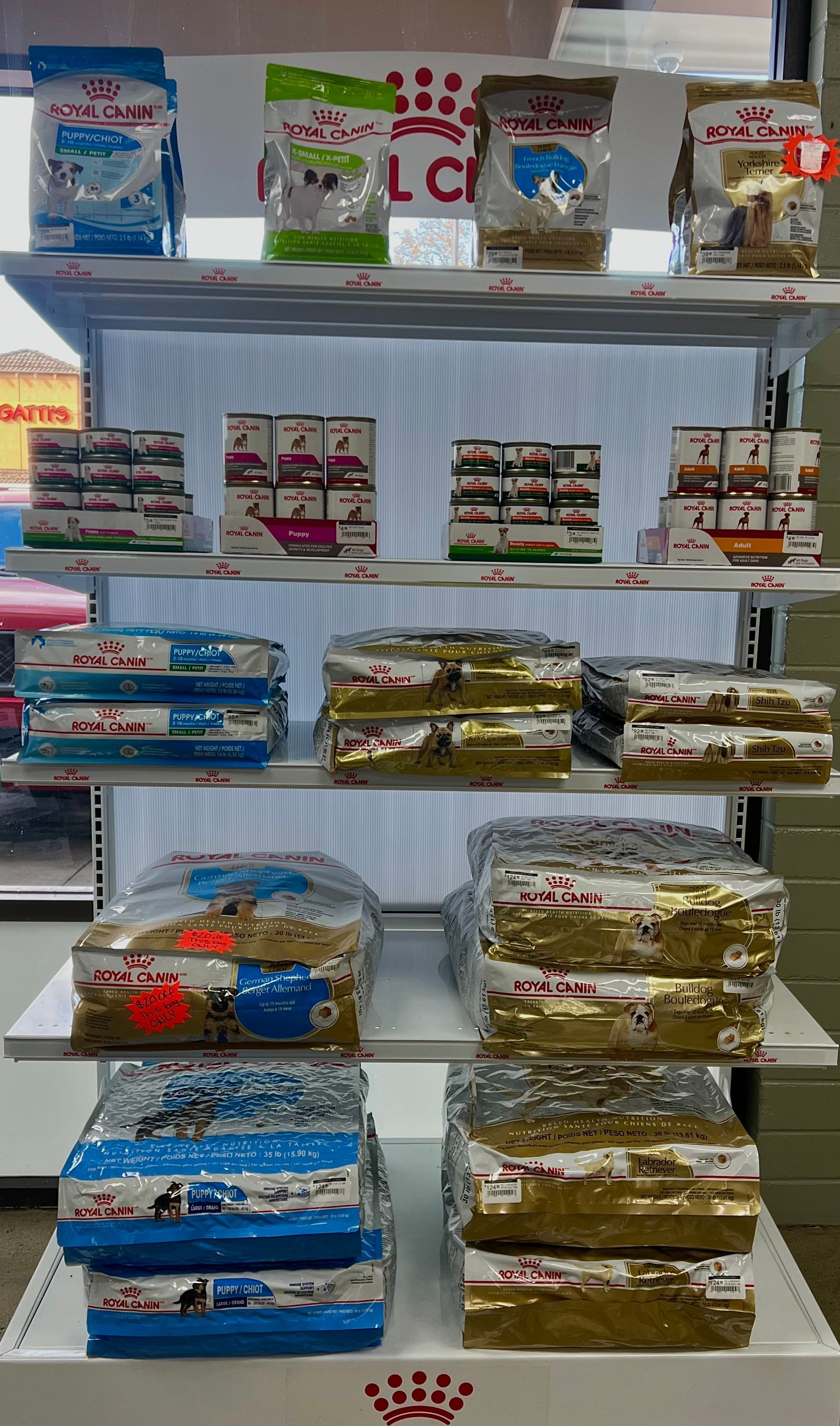 Animal House Pet & Supplies shelf with assorted packaged products and gift baskets in rows