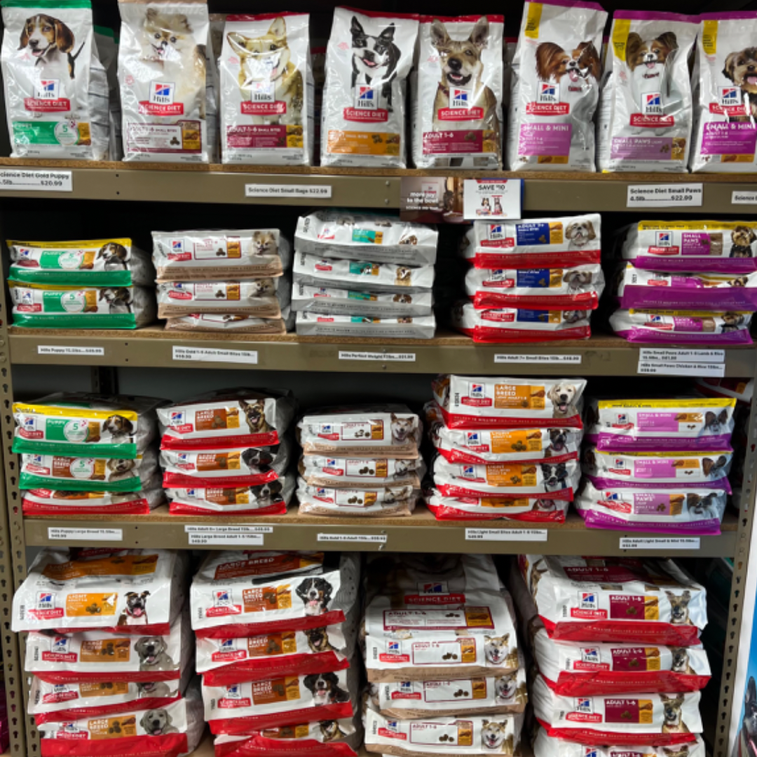 Animal House Pet & Supplies shelves stocked with assorted cat food bags in multiple colors and brands