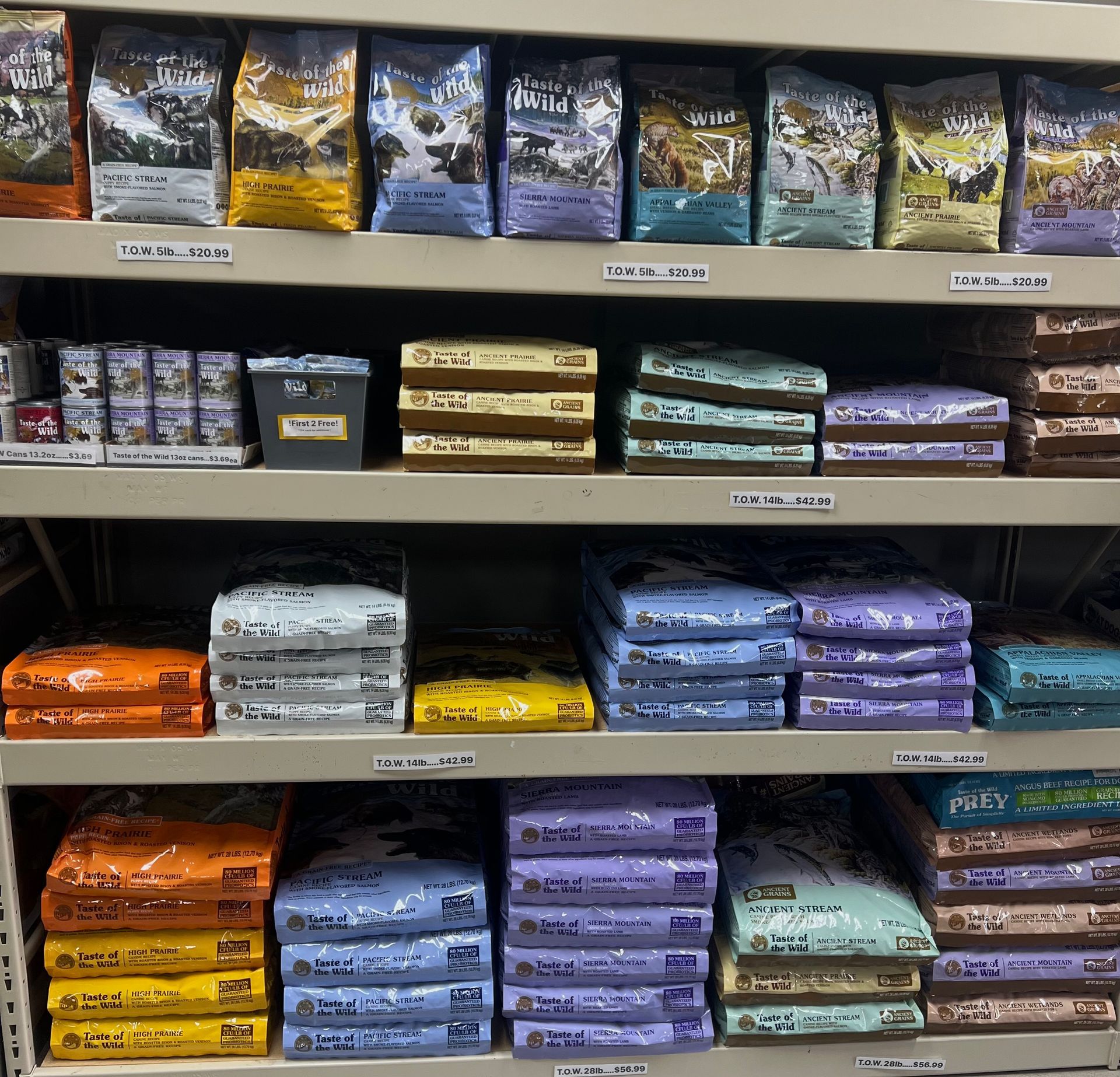 Animal House Pet & Supplies shelves stocked with stacked pet food bags in assorted colors and sizes.