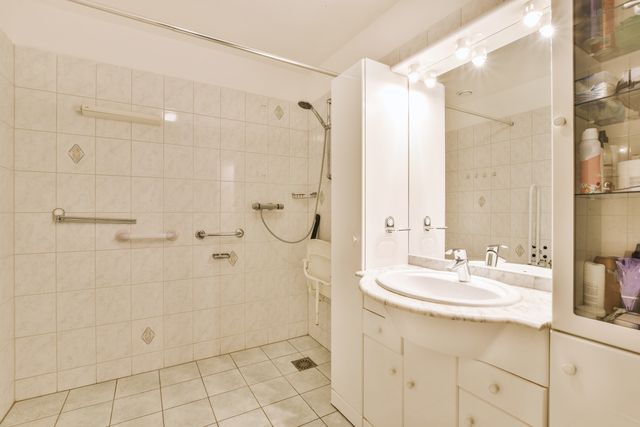 bathroom with grab bars, wheel chair accessible sink