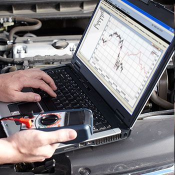A person is using a laptop with a graph on the screen - Curry Truck & Auto