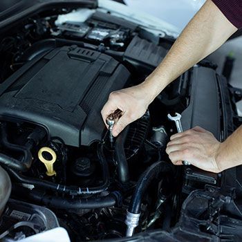 A person is fixing a brake disc on a car - Curry Truck & Auto