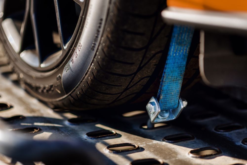 A Close Up Of A Car Wheel With A Blue Strap Attached To It — Torquay & Anglesea Accident Towing Centre In Torquay, VIC