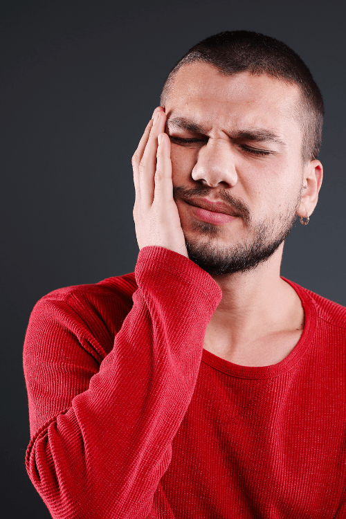 Get same day dental care for emergencies from our top dentist in Escondido CA DENTAL EMERGENCIES IN ESCONDIDO | Man holding cheek in pain | Same day dentist in Escondido CA