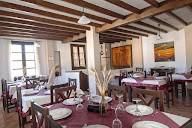 A restaurant with tables and chairs set for a meal.