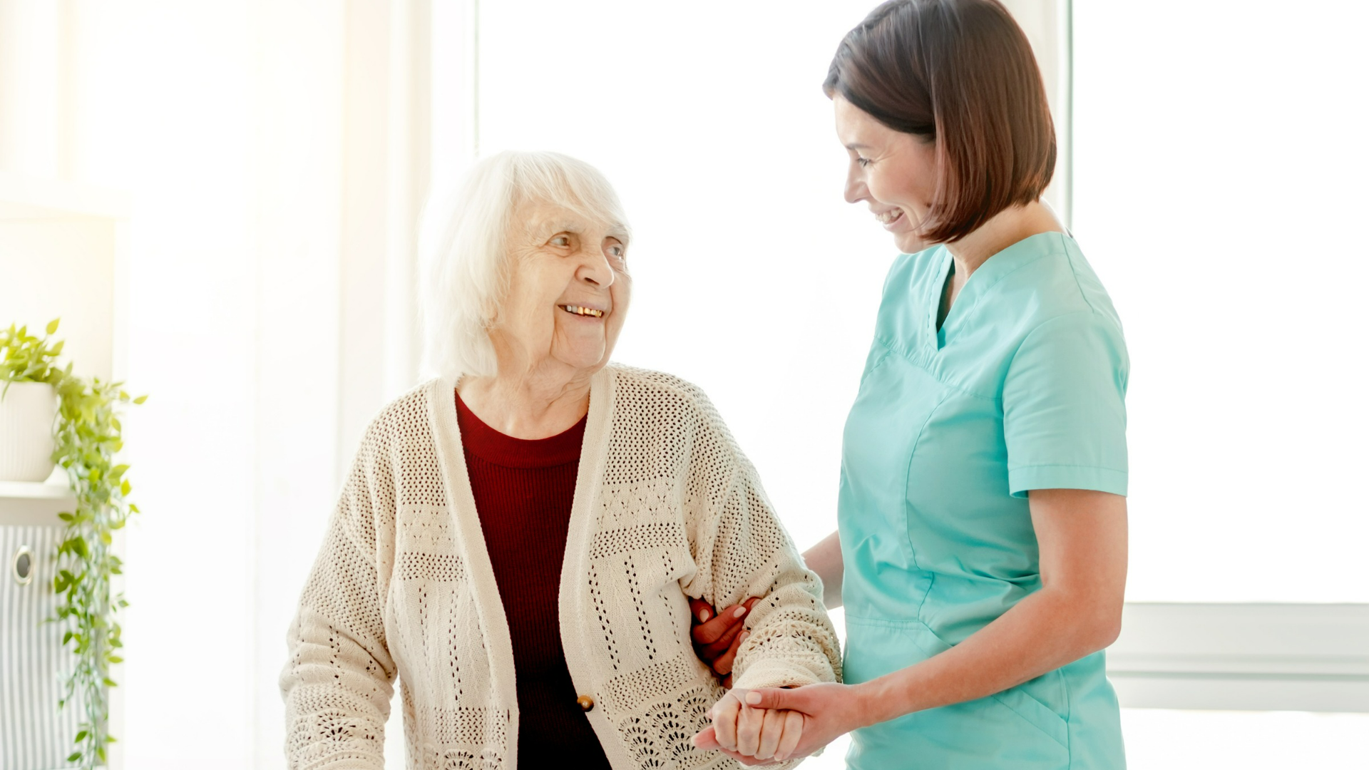 Caregiver walking with elderly woman