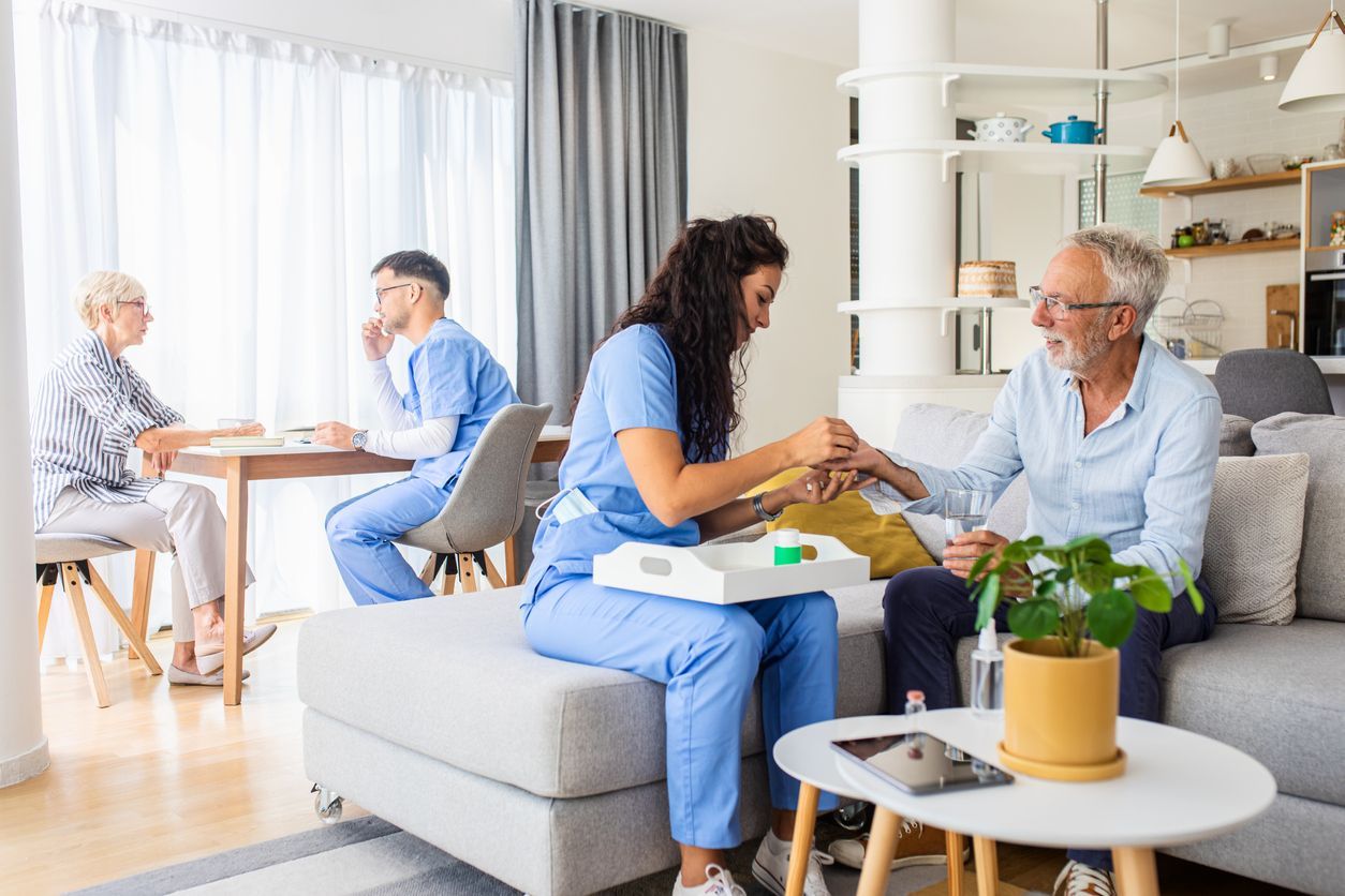 Two nurses are making a home visit to their senior patients.