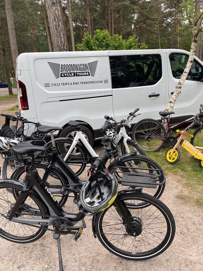 Mountain bike leaning against wooden barrels under a tent at an outdoor market or farm stand