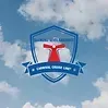 A blue shield with a red cross on it is against a blue sky with clouds.