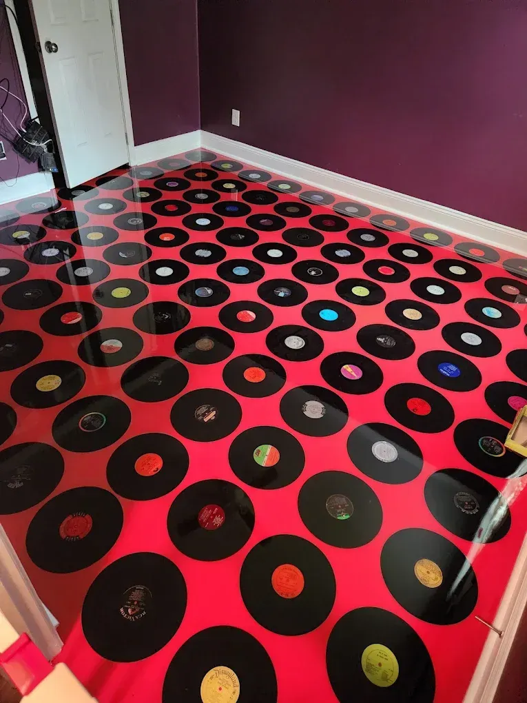 Red room with a red-and-black vinyl record pattern covering the floor.
