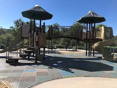 HWH San Diego Hard Money Lender - Real Estate highlights community and recreational appeal near Hilleary Park in Poway. The image showcases open green spaces, playgrounds, walking paths, and picnic areas that reflect the family-friendly lifestyle of the neighborhood.