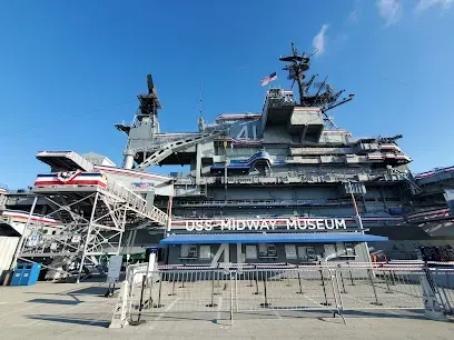 HWH San Diego Hard Money Lender - Real Estate showcases investment opportunities in San Diego near iconic landmarks like the USS Midway Museum. The image highlights the massive aircraft carrier, a historic naval vessel that symbolizes strength, innovation, and the city’s maritime heritage.