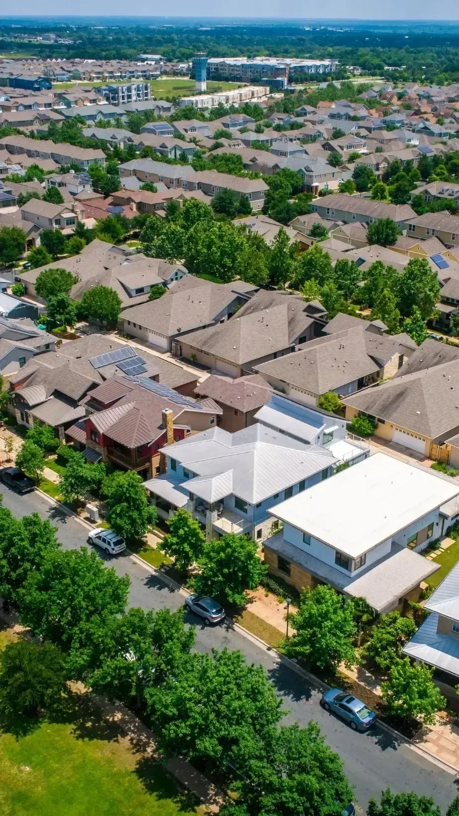 HWH San Diego Hard Money Lender - Real Estate shows a clear aerial view of houses on a sunny day, highlighting the beauty and structure of a thriving neighborhood. The rooftops and streets reflect a well-planned community with strong investment potential.