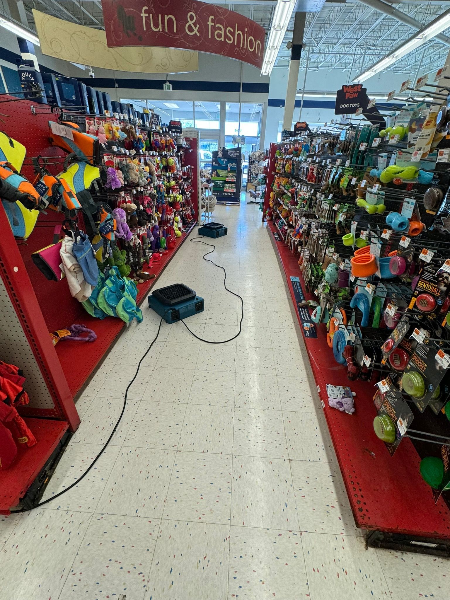 Toy aisle with colorful plush toys on red displays in a store.