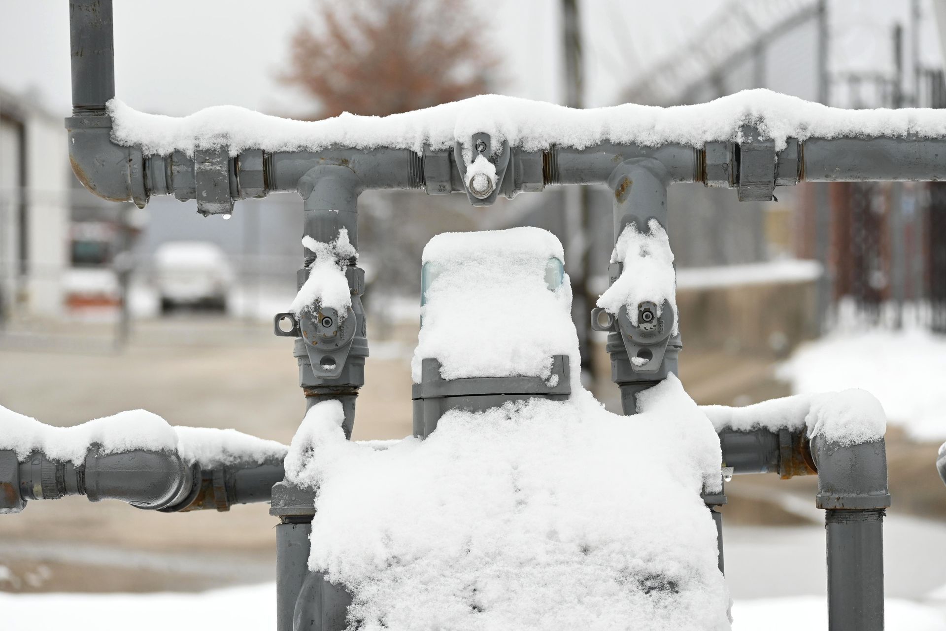 A close up of a pipe covered in snow.