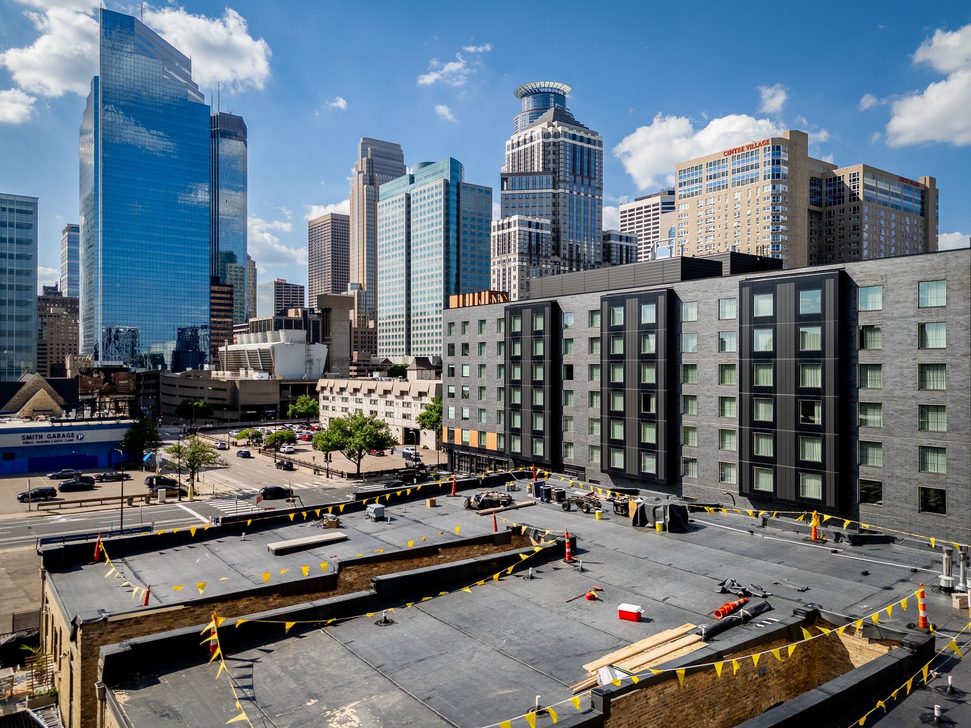 Downtown skyline above a large construction site with excavators and concrete foundations