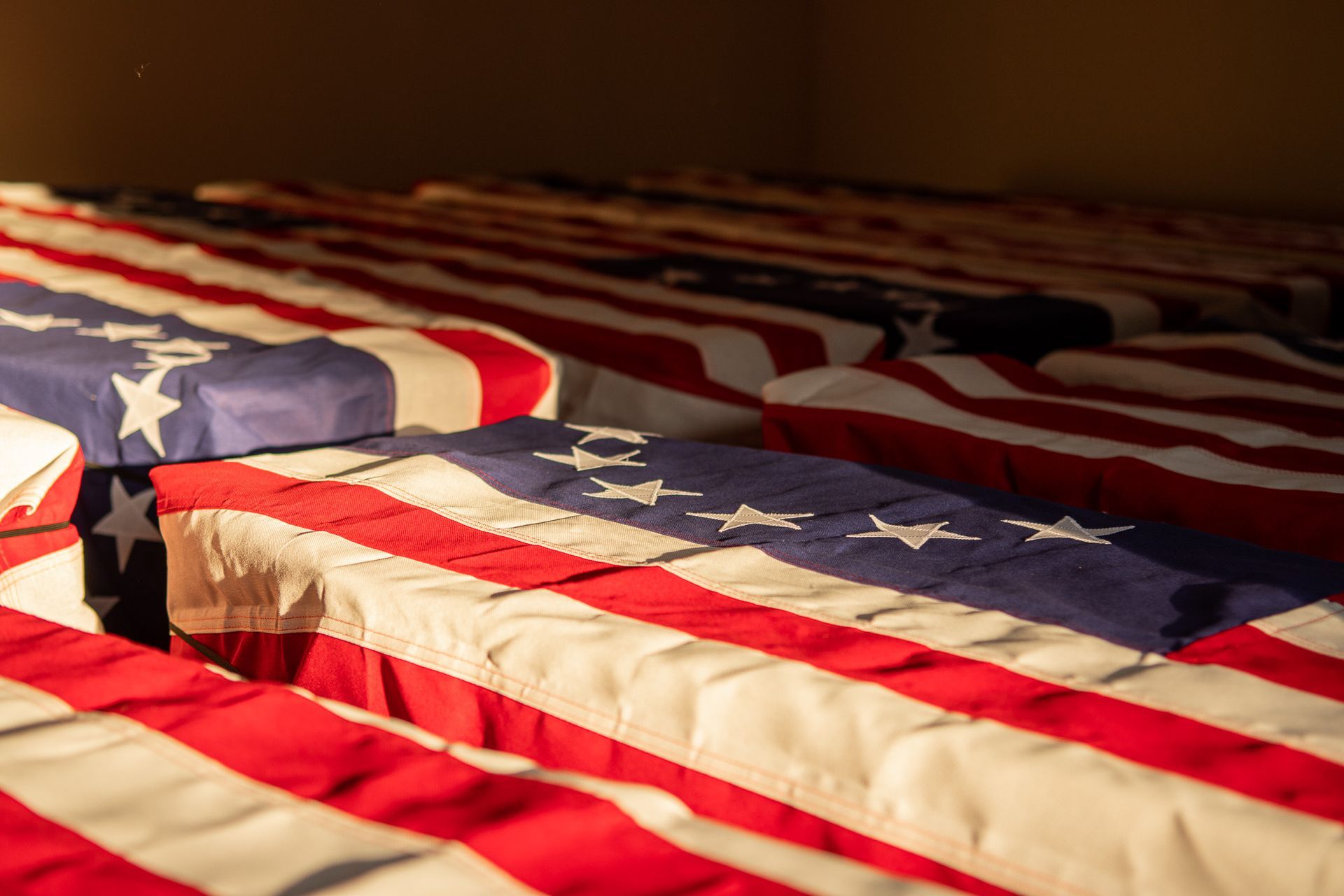 The flag-draped coffins are prepared for their final journey to Camden.