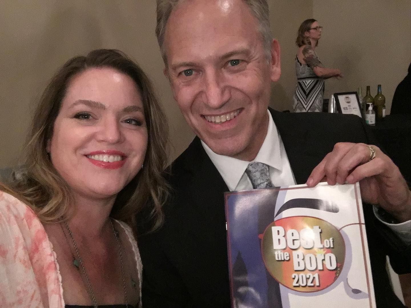 Smiling couple posing indoors, holding a sign that reads “Best of the Best 2024.”