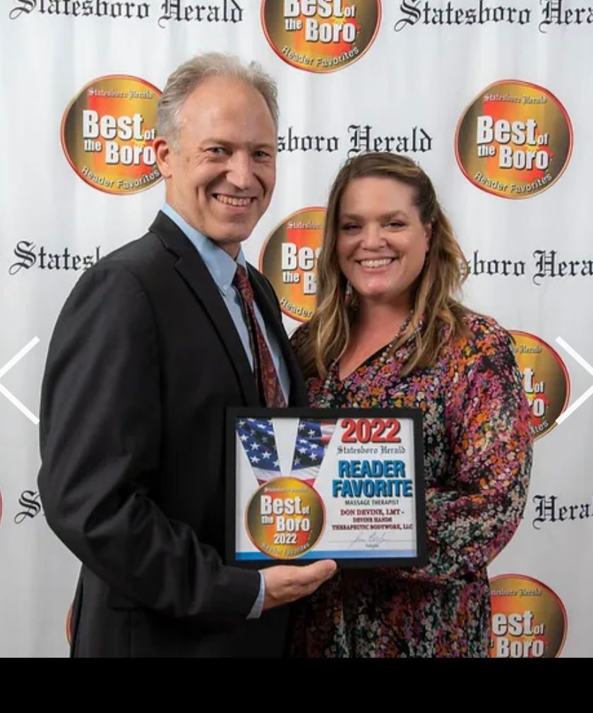 Two people holding a 2022 Best of the Boro award plaque at a newspaper event