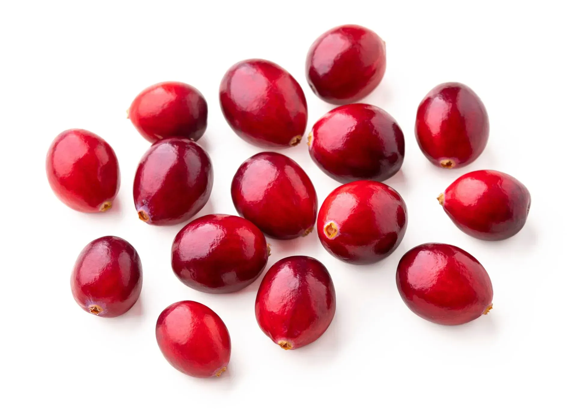 Red cranberries scattered on a white background