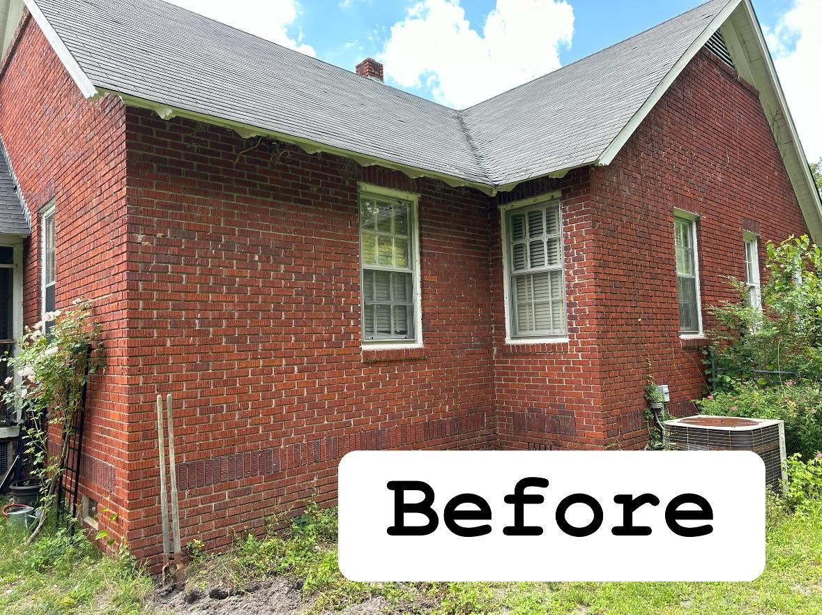 Red brick house exterior with gray shingled roof and a “Before” label over the front yard
