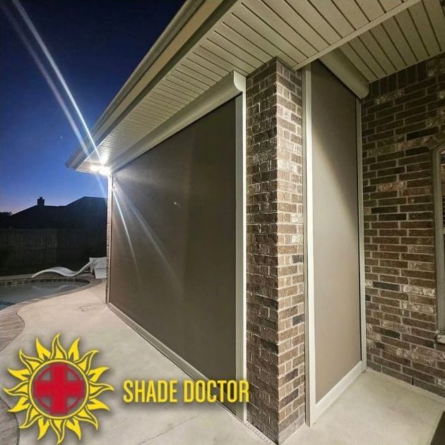 Brick patio with shaded house exterior at dusk, featuring a retractable shade under the eaves and Shade Doctor logo