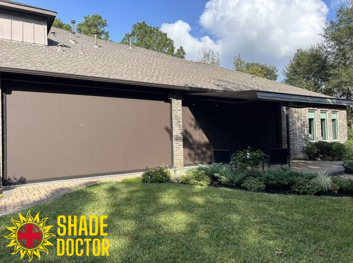 Brown house exterior with a large garage, covered entry, and landscaped front yard under a cloudy sky