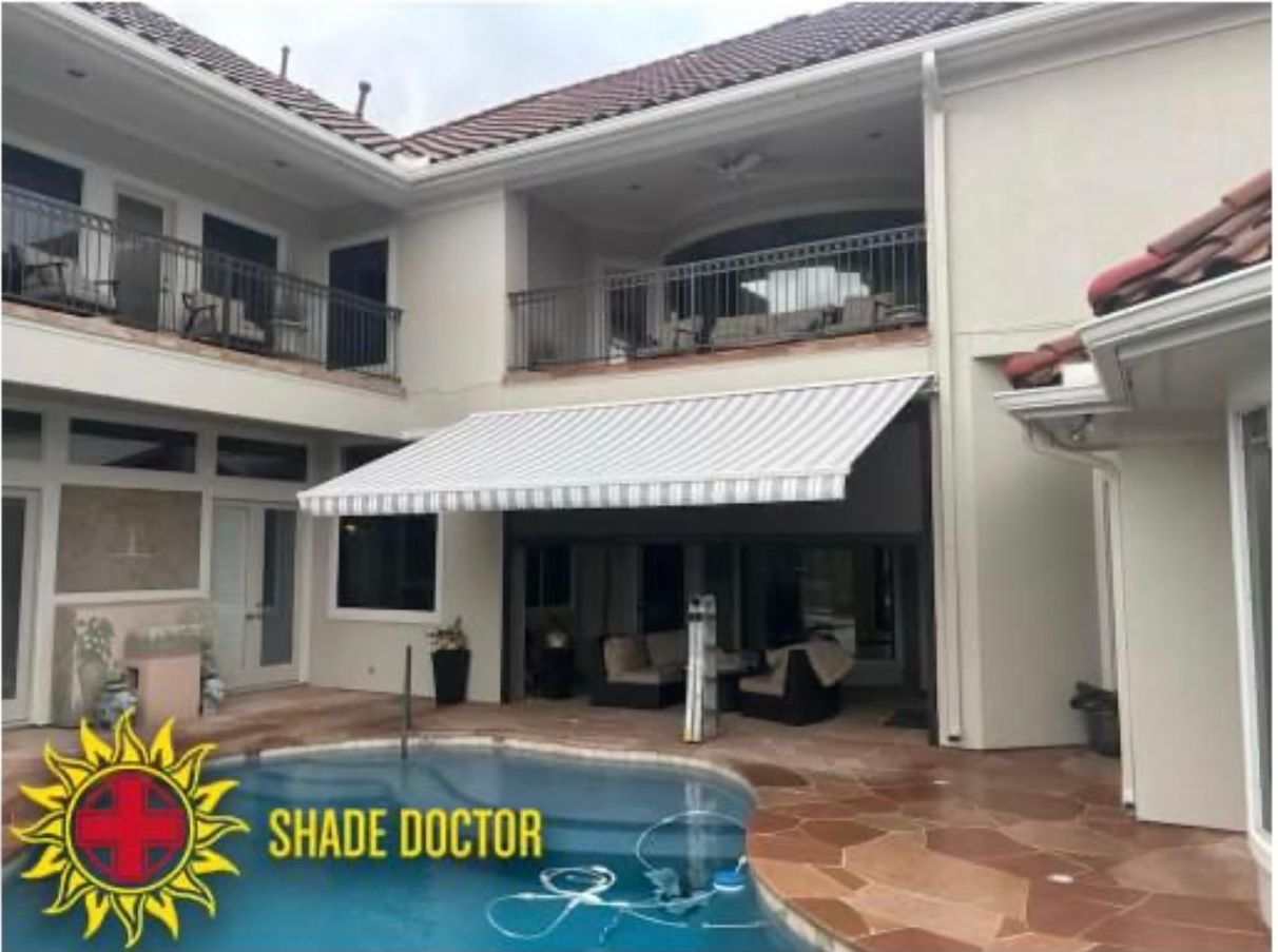 Two-story house patio with retractable awning and pool, featuring Shade Doctor logo in the corner